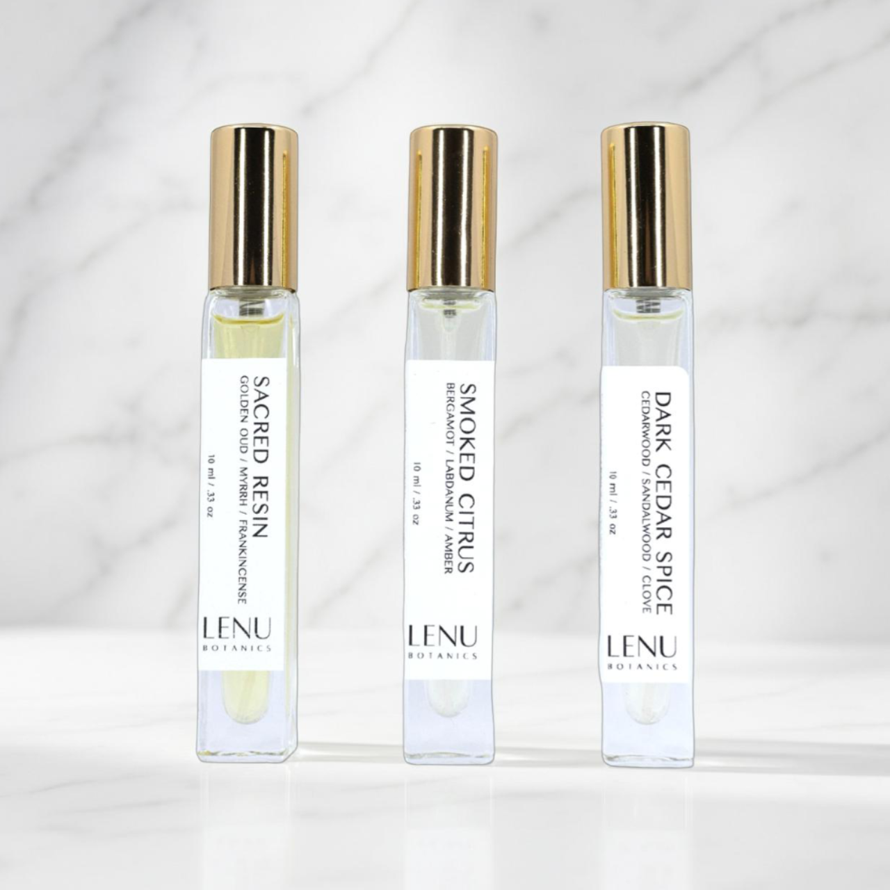 Three LENU Botanics perfume bottles on a white background