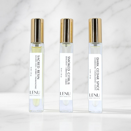 Three LENU Botanics perfume bottles on a white background